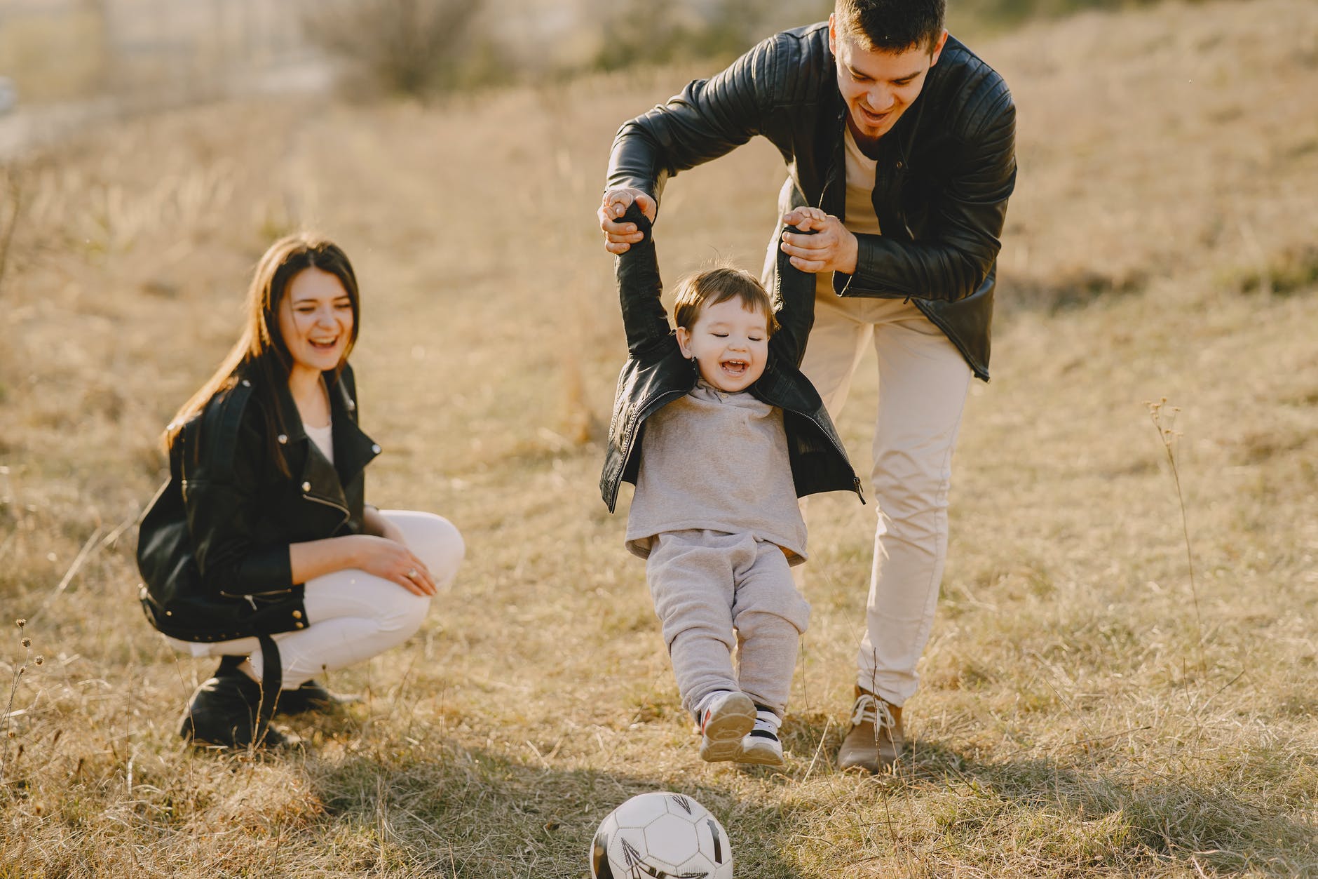 photo of family having fun with soccer ball